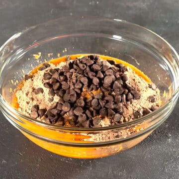 Glass bowl with orange mixture, brownie mix and chocolate chips. 