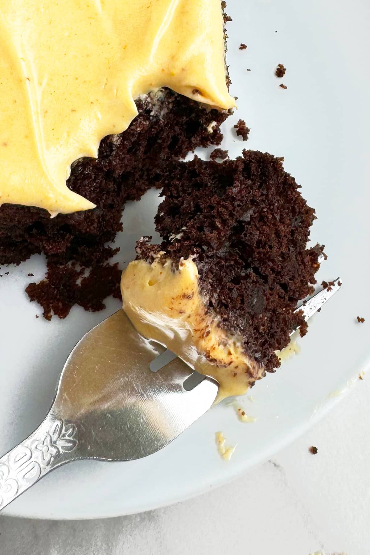 Closeup Shot of Fork Full of Cake on White Dish. 