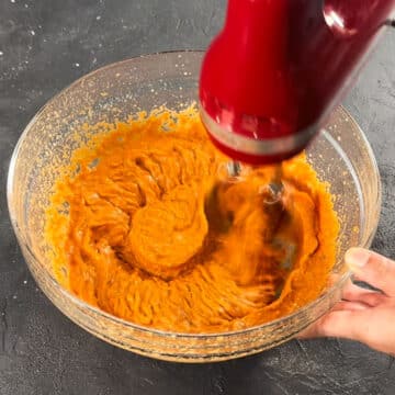 Ingredients being together with hand held mixer. 