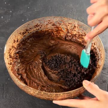 Mini chocolate chips being folded in the cake batter. 