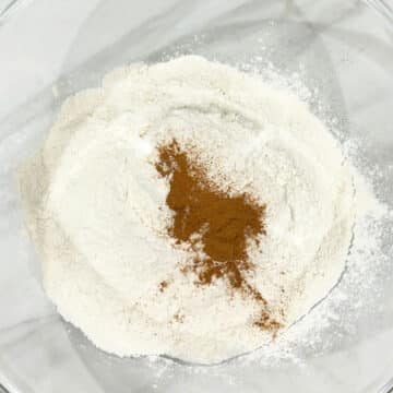 Dry ingredients about to get mixed  together in a glass bowl. 