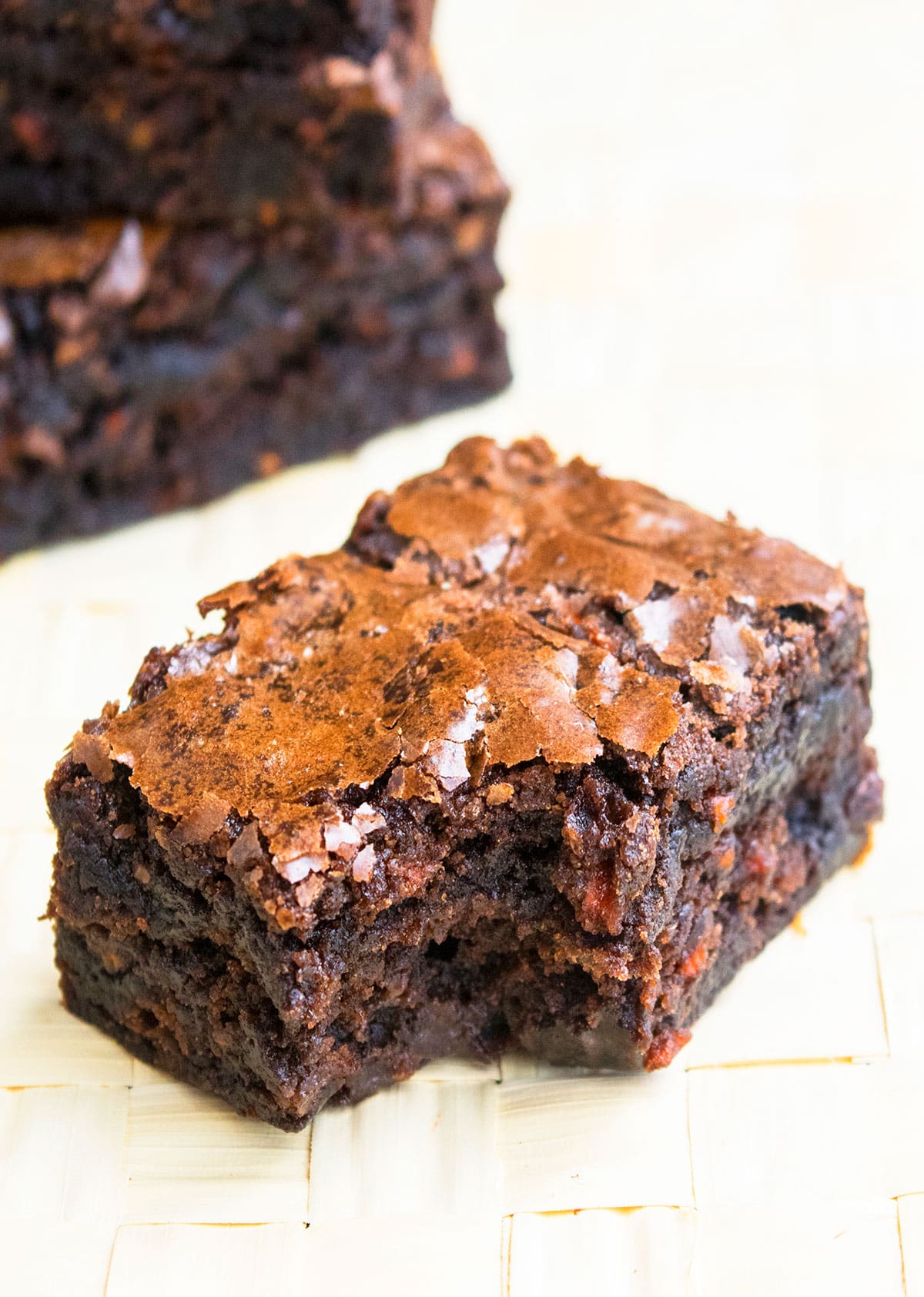 Partially Eaten Slice of Brownie on Wood Background. 