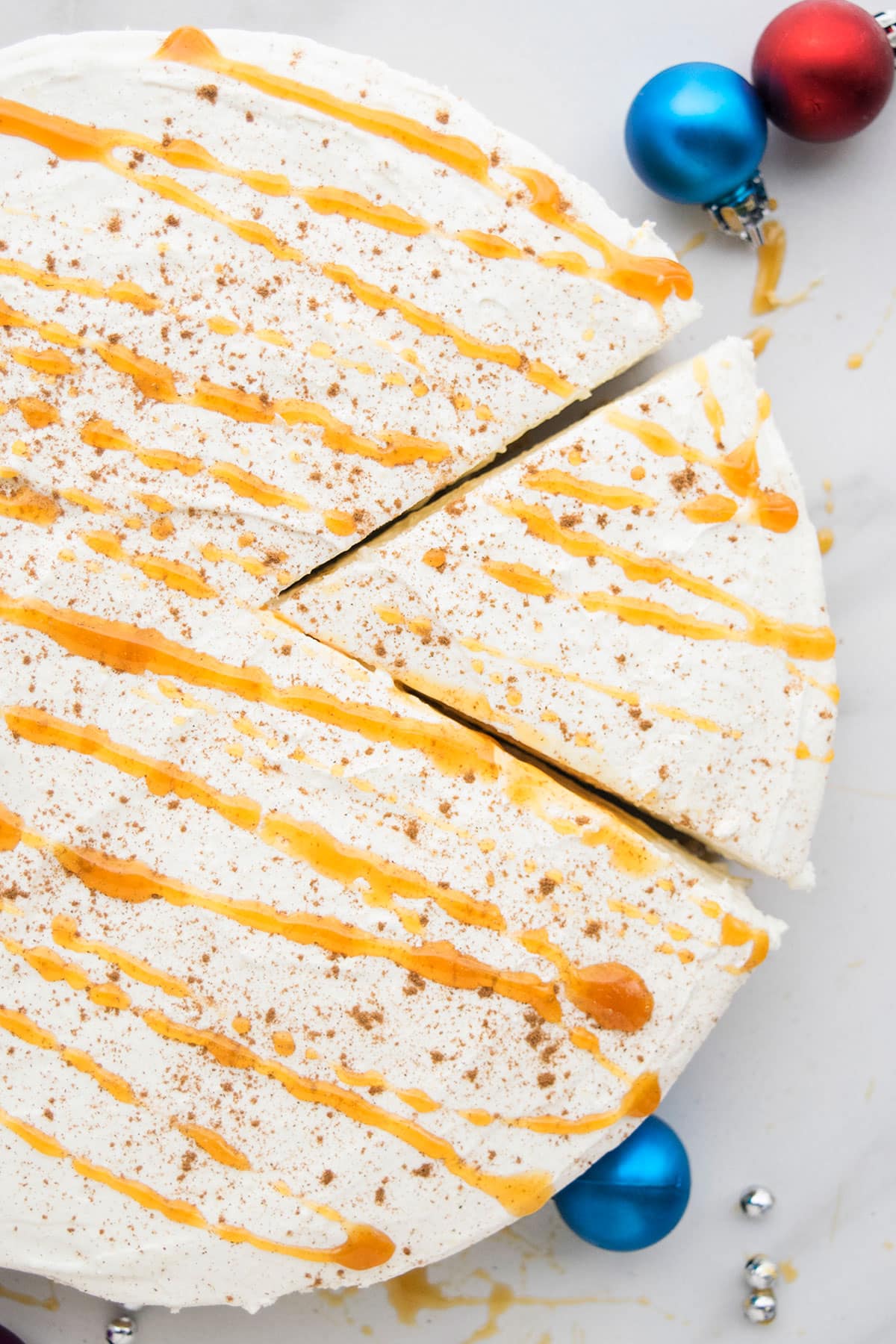 Overhead Shot of Christmas Cheesecake on White Marble Background. 