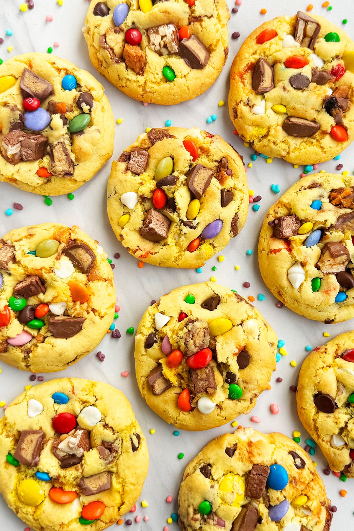 Loaded Halloween Cookies on White Marble Background- Overhead Shot. 