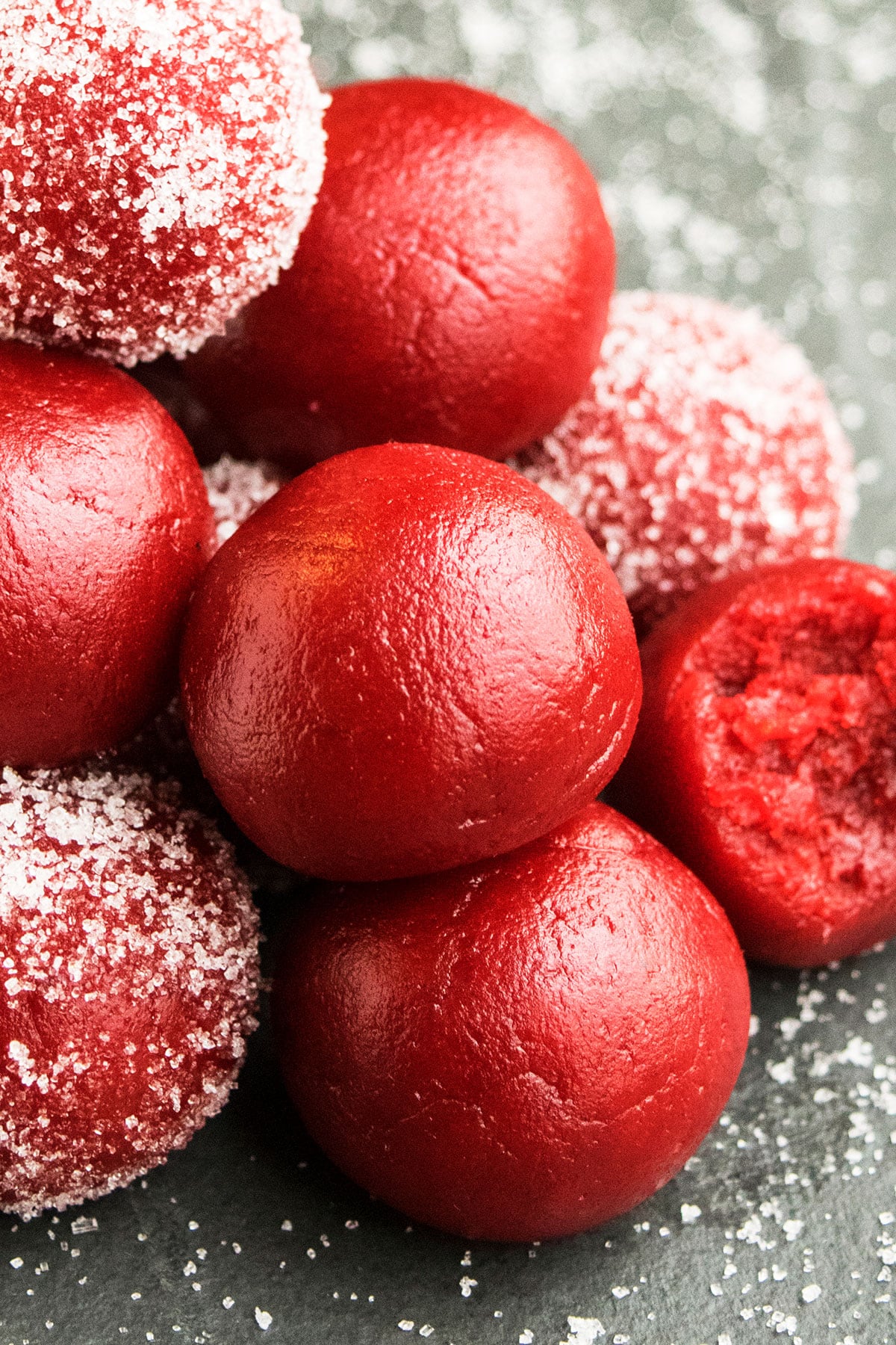 Valentine's Day Red Cake Truffles Stacked on Rustic Gray Background.