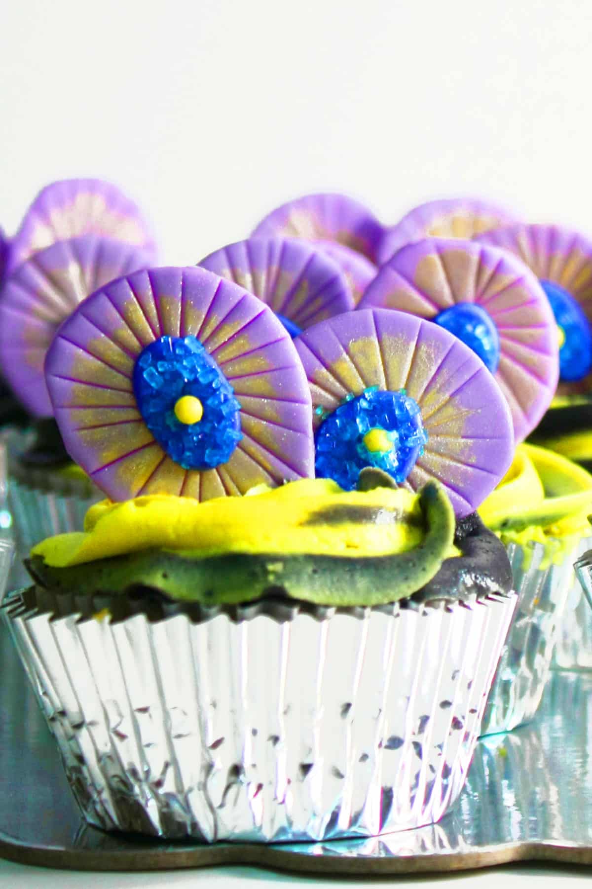 Fondant Feather Toppers on Cupcakes in Silver Liner.