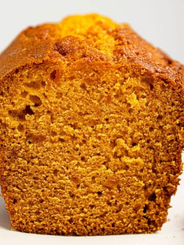 Easy Pumpkin Banana Bread Loaf With Cake Mix on White Dish.