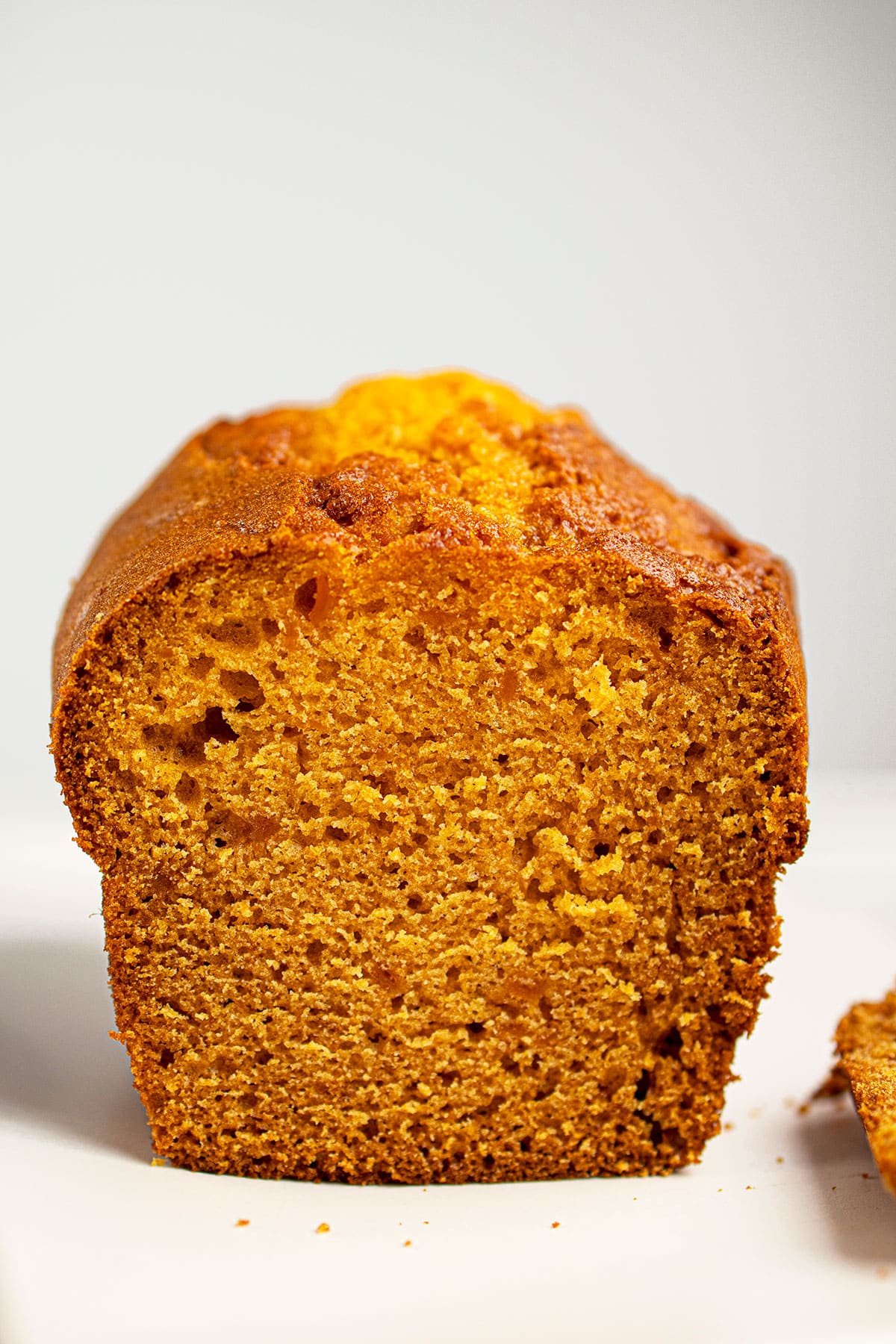 Easy Pumpkin Banana Bread Loaf With Cake Mix on White Dish.