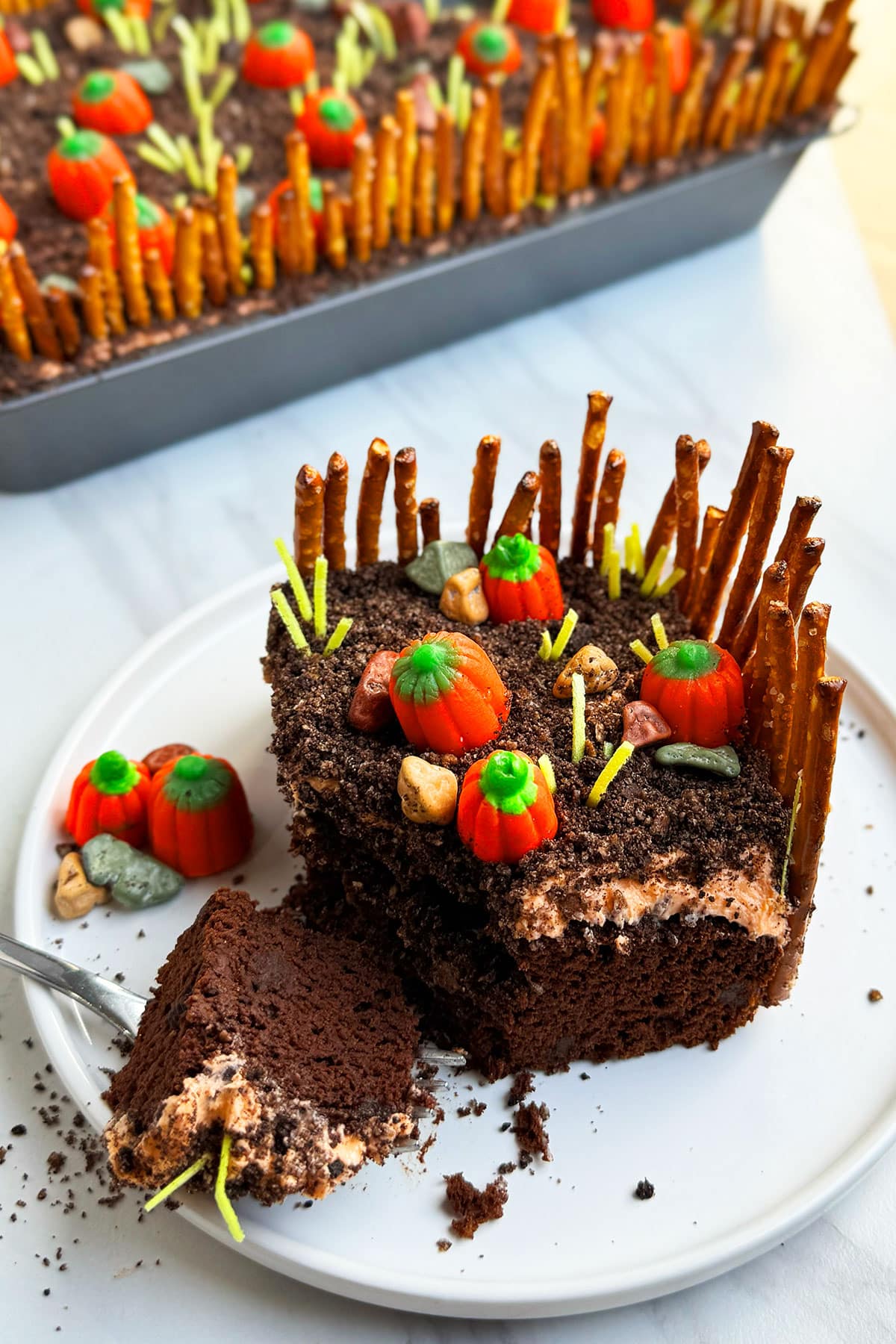 Slice of partially eaten cake on white dish.  
