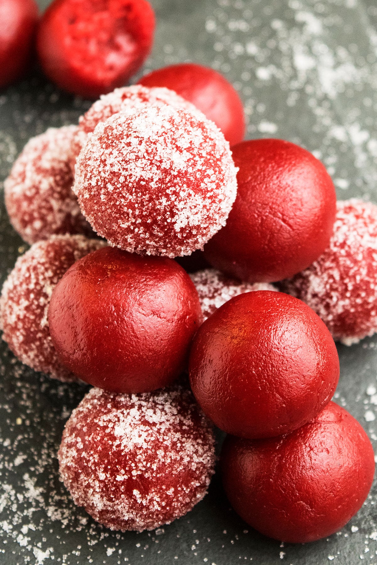 Easy Red Velvet Truffles With Cake Mix Stacked on Rustic Gray Background.