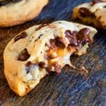 Easy Stuffed Salted Caramel Chocolate Chip Cookies That Are Partially Eaten on Rustic Background.