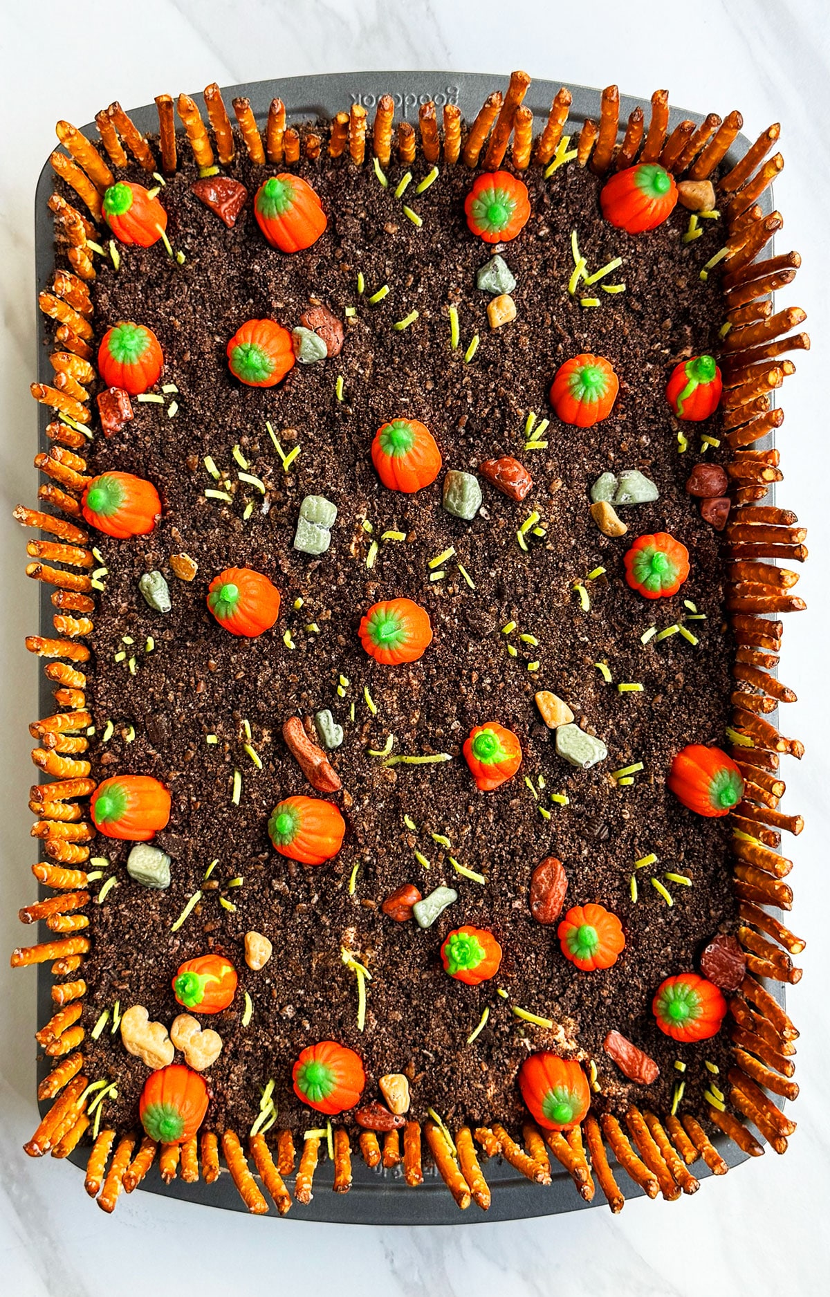 Easy pumpkin patch cake for Fall and Thanksgiving that's decorated with candies and pretzels- Overhead Shot. 