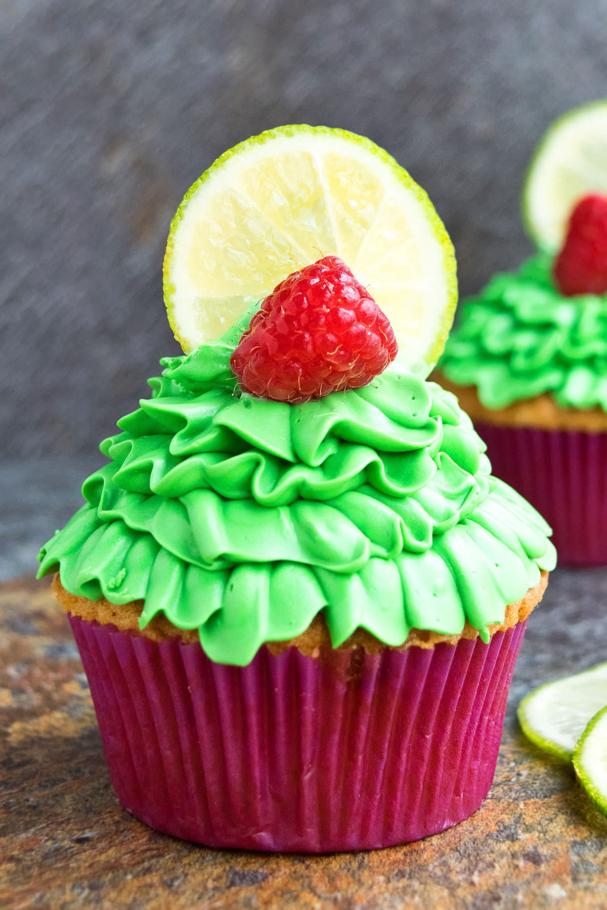 Easy Lemon Raspberry Cupcakes With Cream Cheese Frosting on Rustic Background.