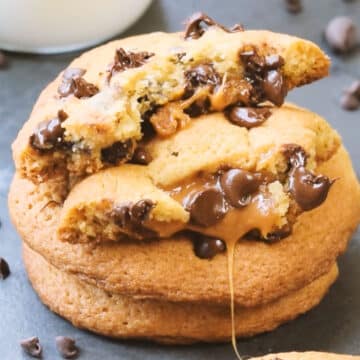 Stack of baked cookies with one broken in half. 