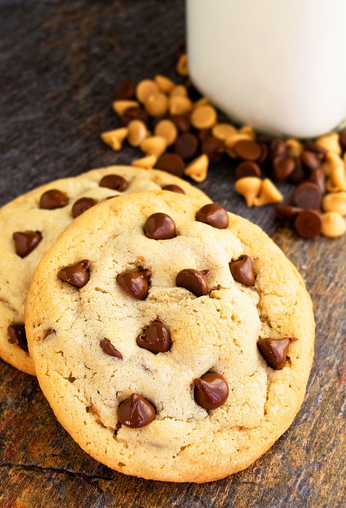 Two Stuffed Cookies on Rustic Brown Background With Coffee Mug in the Background. 