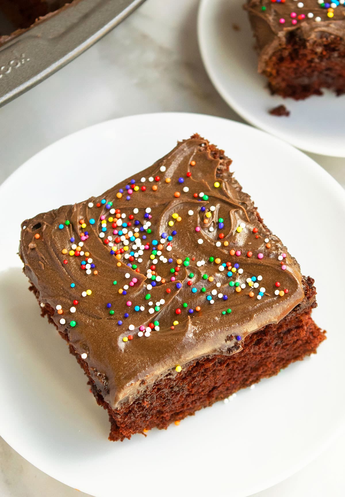 Closeup Shot of Chocolate Frosting and Sprinkles on Cake. 