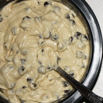 Chocolate chips being stirred into the batter. 