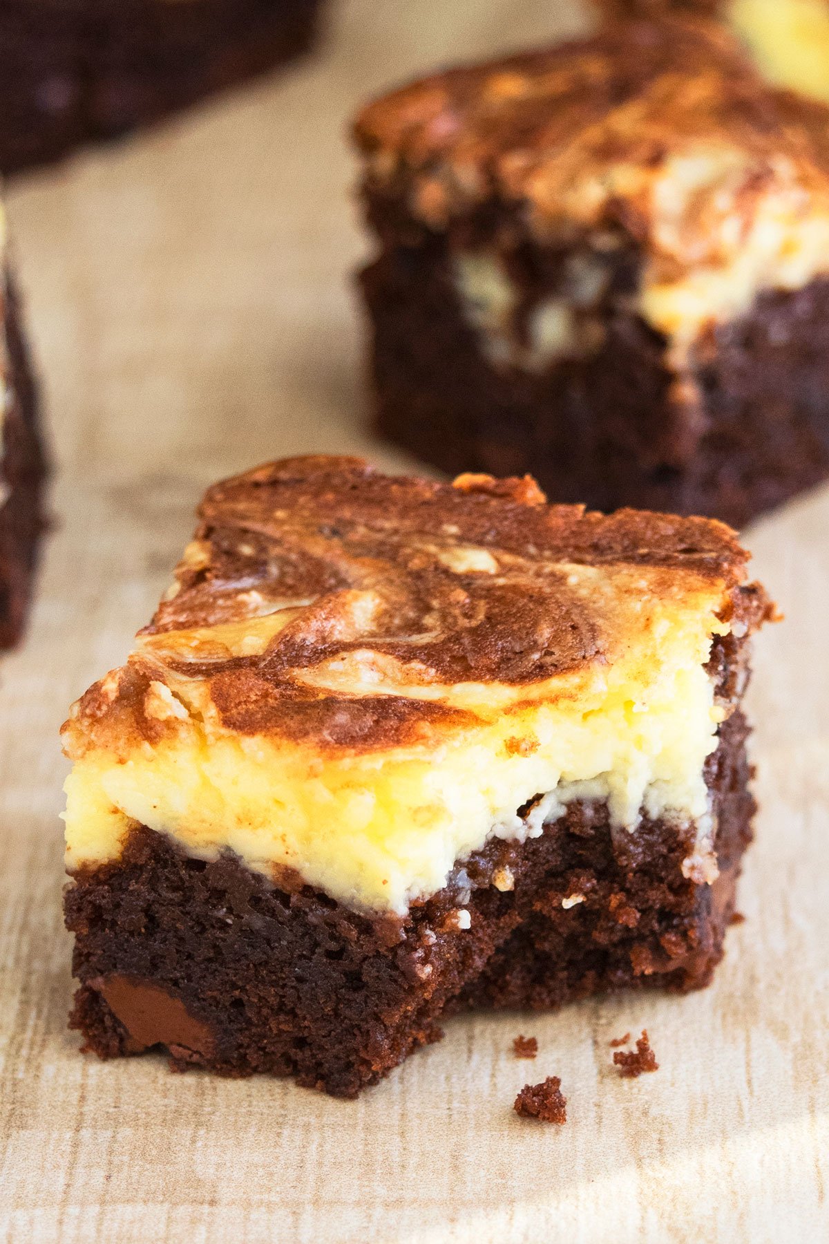 Partially Eaten Cream Cheese Brownies on Wood Background. 