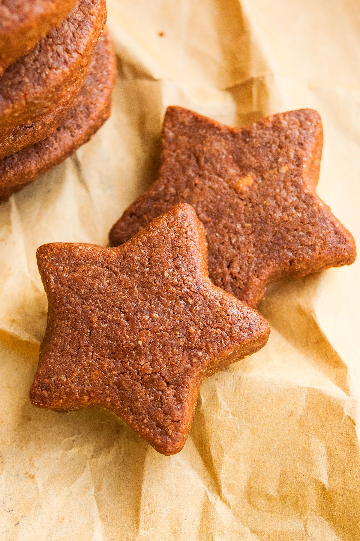 Star Shaped Cut Out Chocolate Cookies on Brown Parchment Paper. 