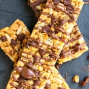 Easy No Bake Chewy Homemade Granola Bars With Peanut Butter and Chocolate Chips on Dark Gray Background.