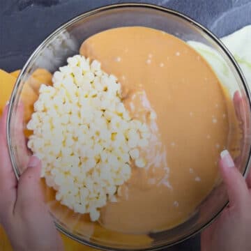 White chocolate chips and peanut butter in large glass bowl.