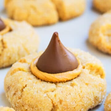 Easy Classic Peanut Butter Blossoms on White Marble Background.