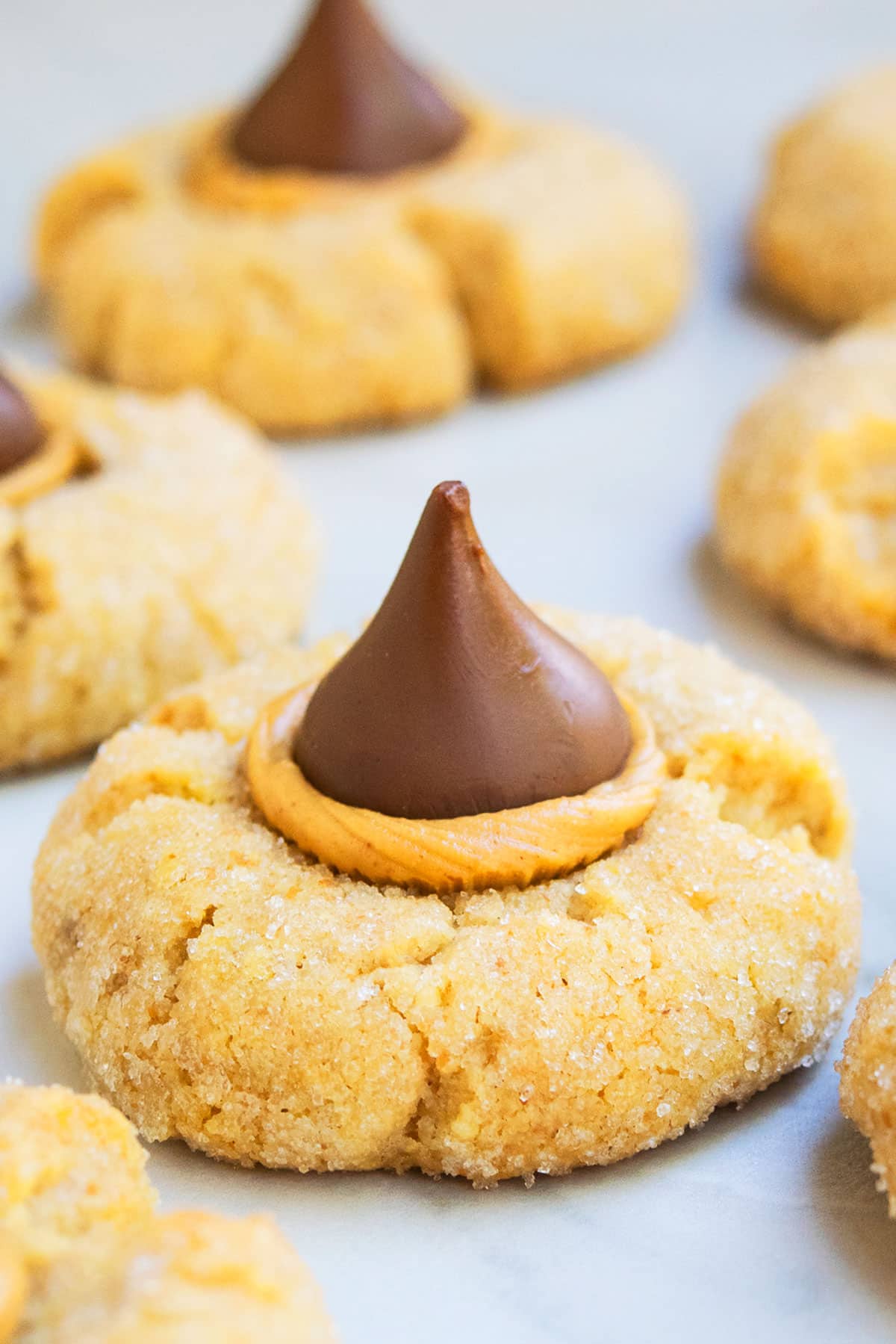 Easy Classic Peanut Butter Blossoms on White Marble Background.  