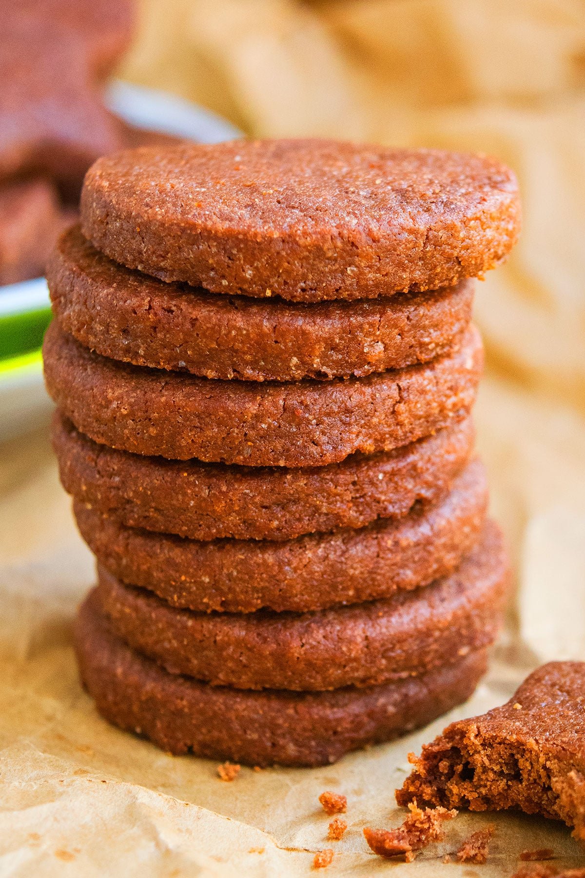 Stack of Easy Cut Out Chocolate Sugar Cookies on Sheet of Brown Parchment Paper. 