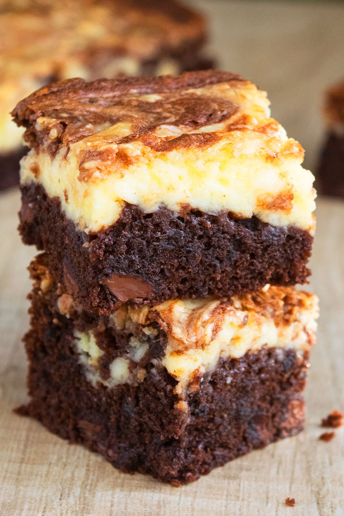 Stack of Easy Chocolate Cheesecake Brownies From Scratch on Wood Background. 