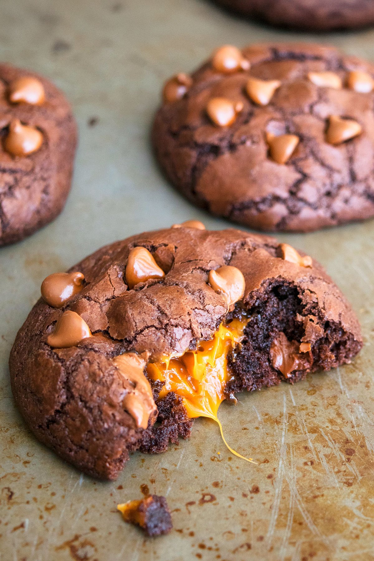 Partially Eaten Cookie With Caramel Filling Oozing out From the Center.