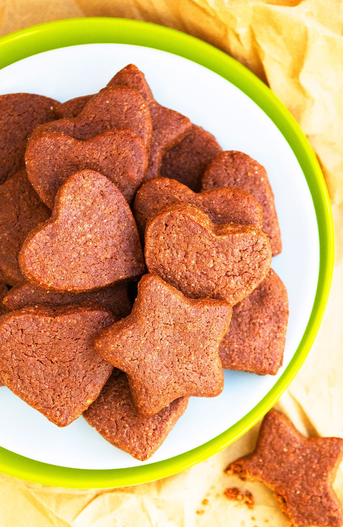 Cut Out Cocoa Sugar Cookies on Greenish White Dish. 