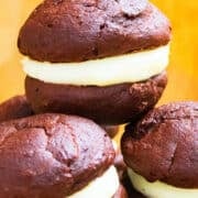 Stack of Easy Chocolate Whoopie Pies With Marshmallow Filling on Yellow Background.