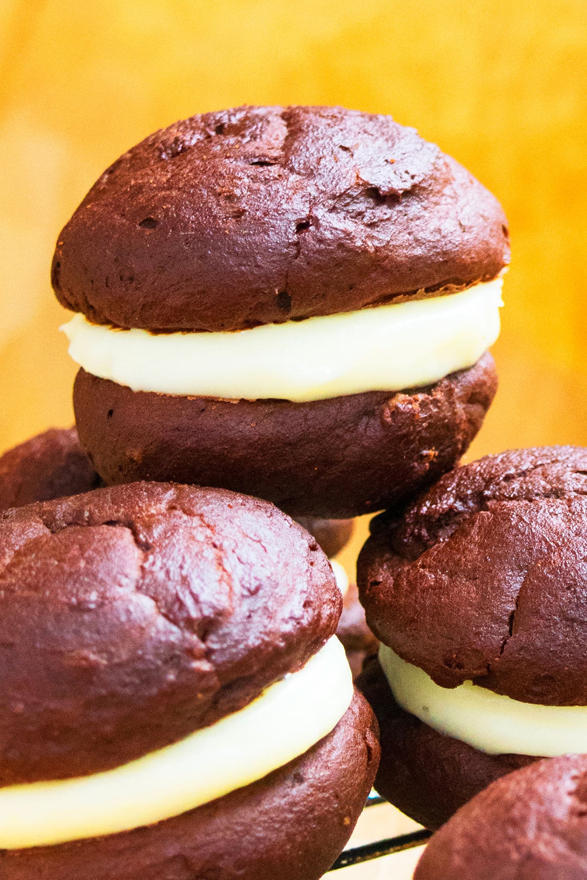 Stack of Easy Chocolate Whoopie Pies With Marshmallow Filling on Yellow Background.