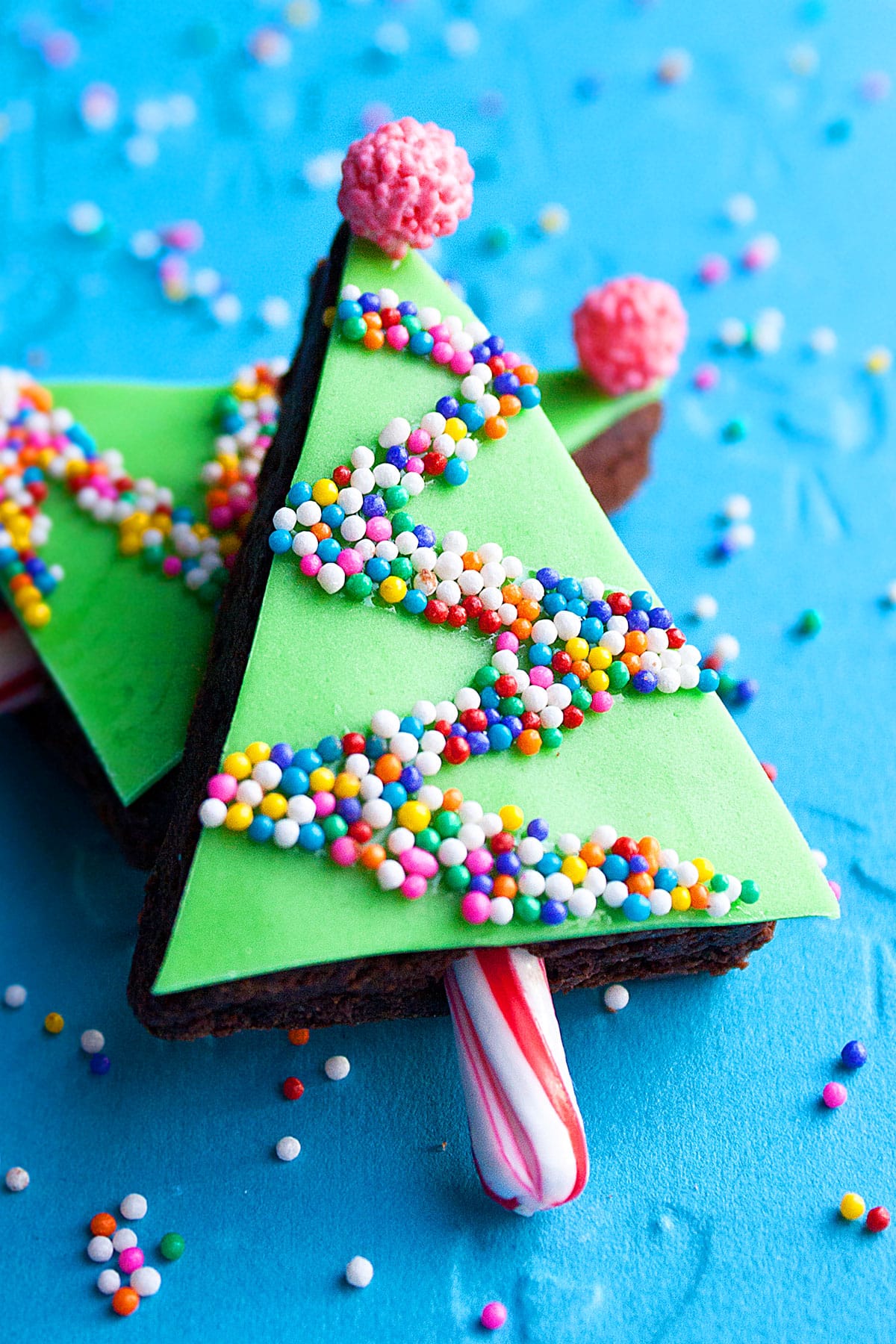 Easy Christmas Tree Brownie Bites With Fondant on Blue Background.