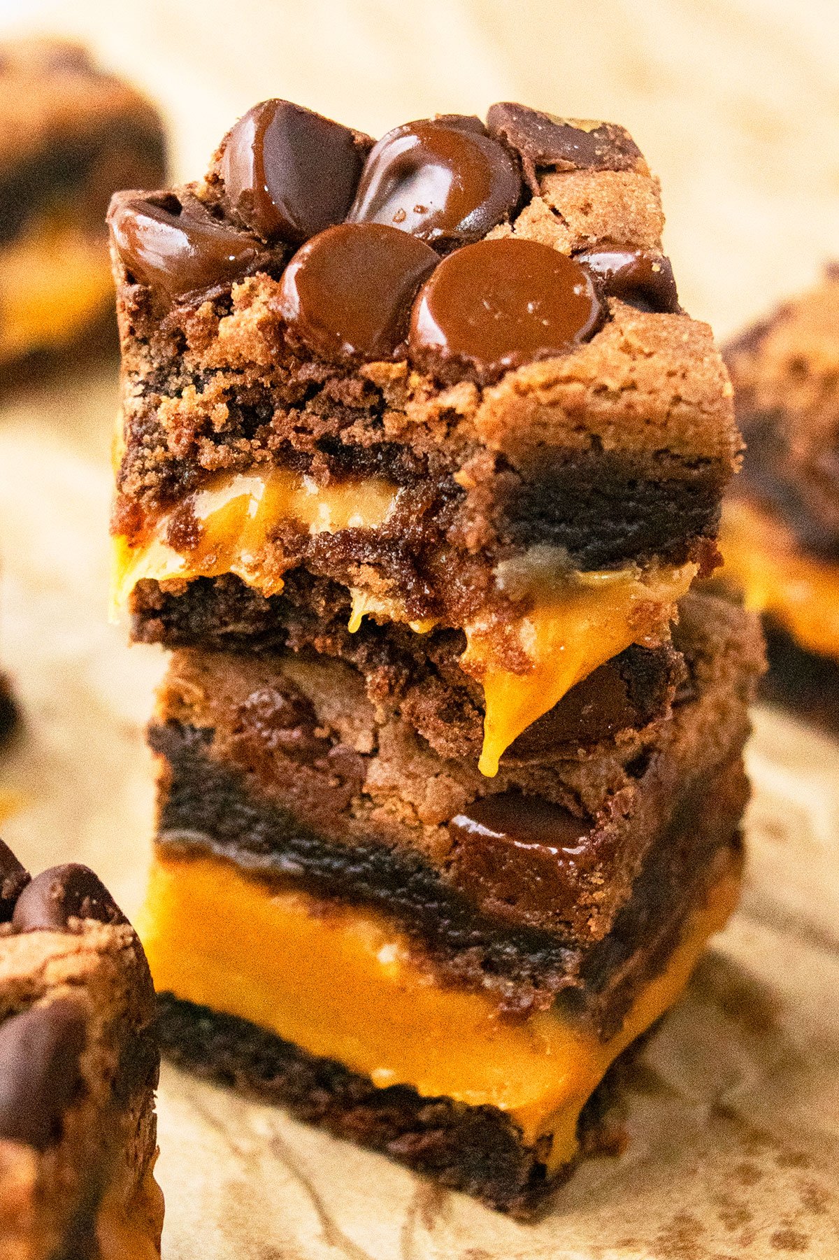 Stack of Easy Chocolate Caramel Brownies With Brownie Mix on Brown Parchment Paper. 