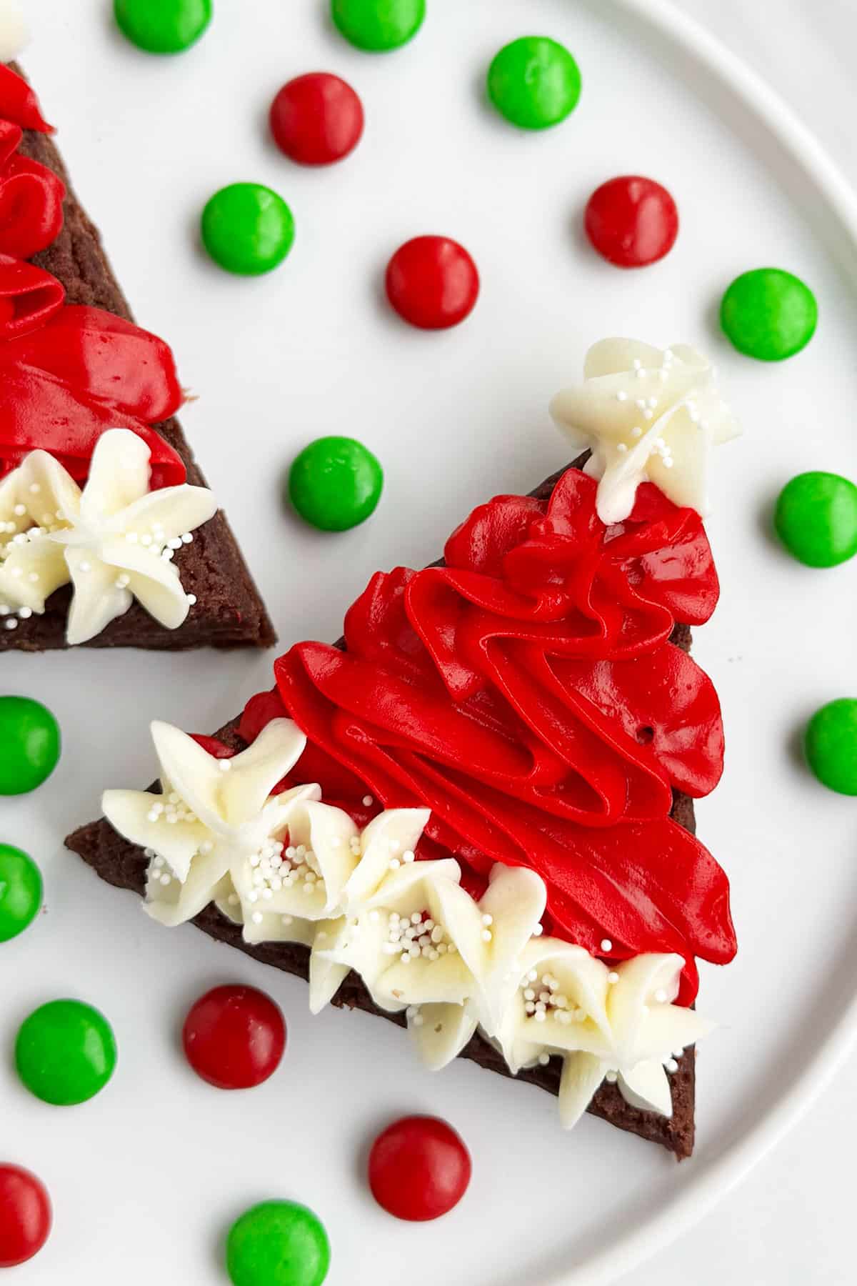 Easy Santa Hat Brownies With Buttercream Frosting For Christmas on White Dish. 