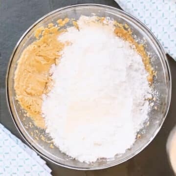 Dry ingredients added to wet ingredients in glass bowl. 