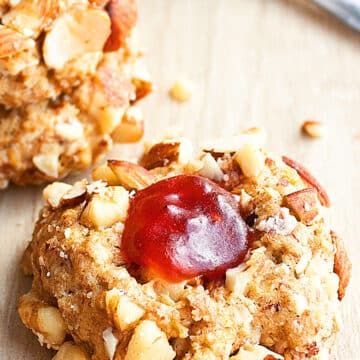 Easy Peanut Butter and Jelly Cookies (Thumbprints) on Rustic Wood Background.