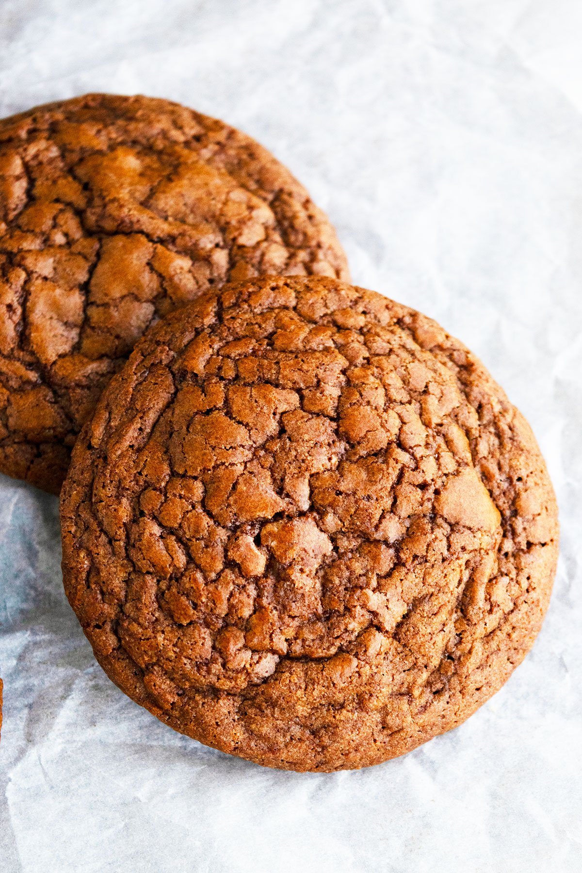 Closeup Shot of Cookie With Crackle Crinkle Tops on Parchment Paper. 