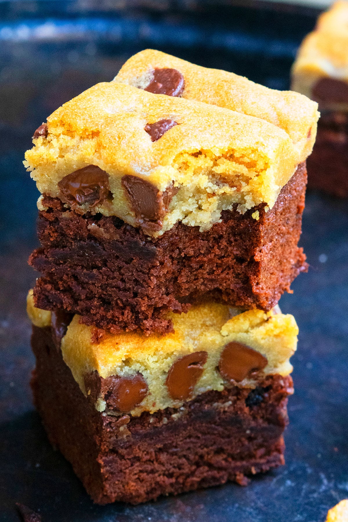 Stack of Easy Brookies Recipe (Brownie Cookie Hybrid) on Dark Metal Tray. 