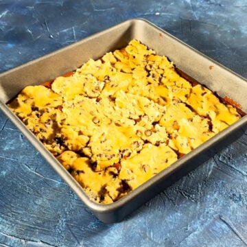 Raw cookie dough spread out on top of the brownie batter. 