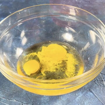 Eggs, oil and water in a glass bowl. 