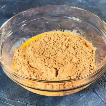 Brownie mix powder added to glass bowl. 