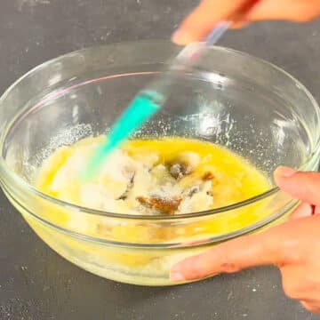 Melted butter, granulated sugar and brown sugar in glass mixing bowl.