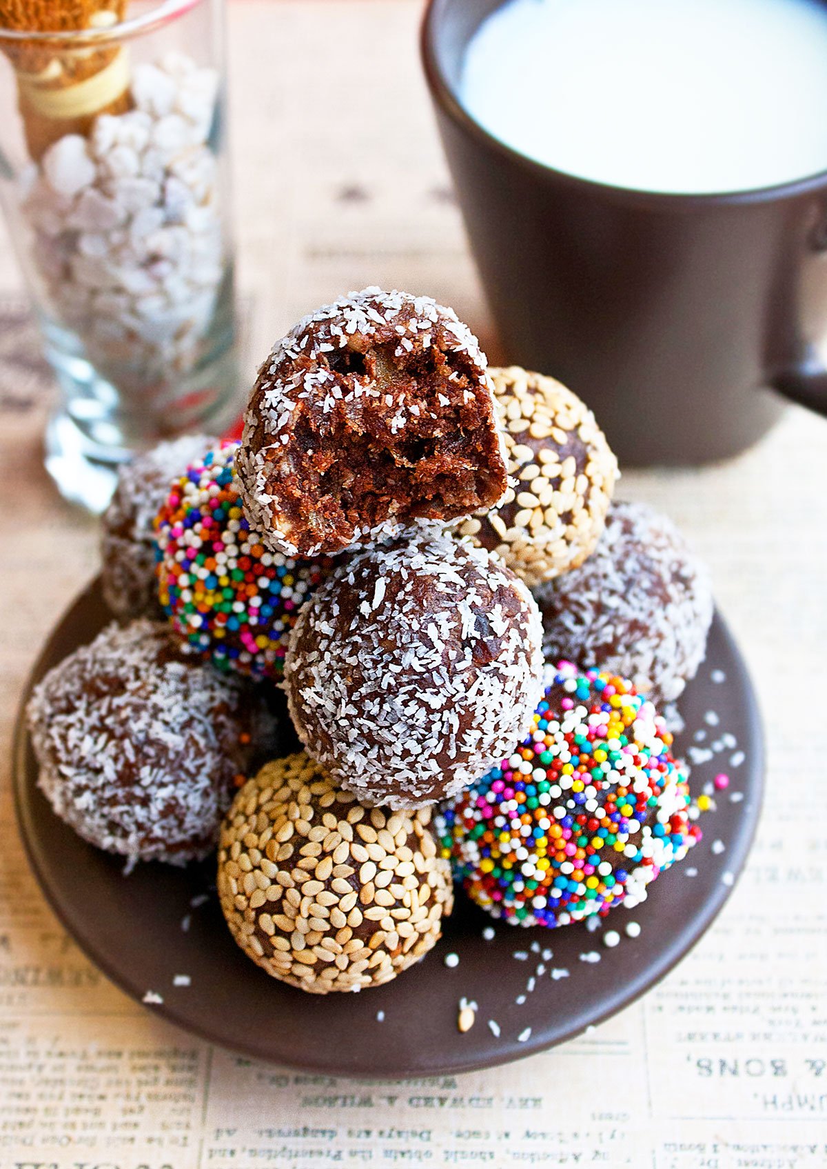 Stack of Easy Chocolate Date Balls in a Small Brown Dish.