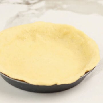 Pie crust spread out in pan.