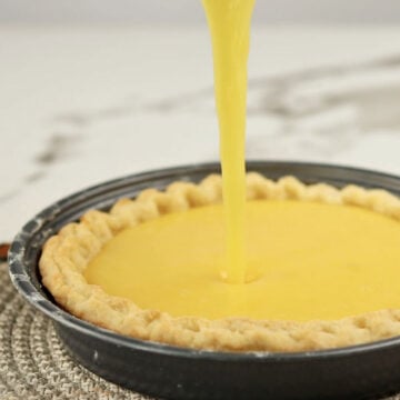 Lemon filling being poured into a crust. 