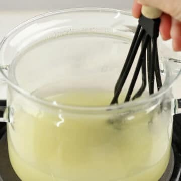 Water, cornstarch, lemon juice, sugar, lemon zest being whisked in glass pot. 