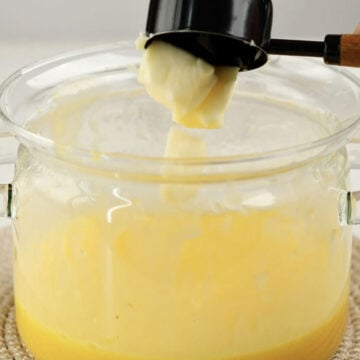 Butter being added to lemon filling. 