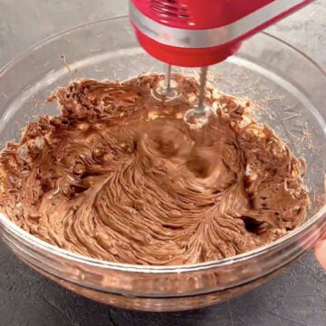 Ingredients being mixed with a hand mixer. 